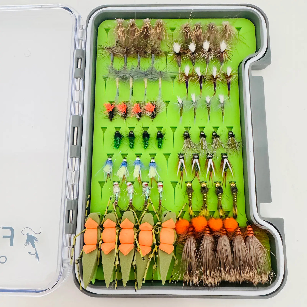Overhead view of the All-Water Arsenal fly box showing rows of dry flies, nymphs, eggs, green hoppers, and Stimulators.