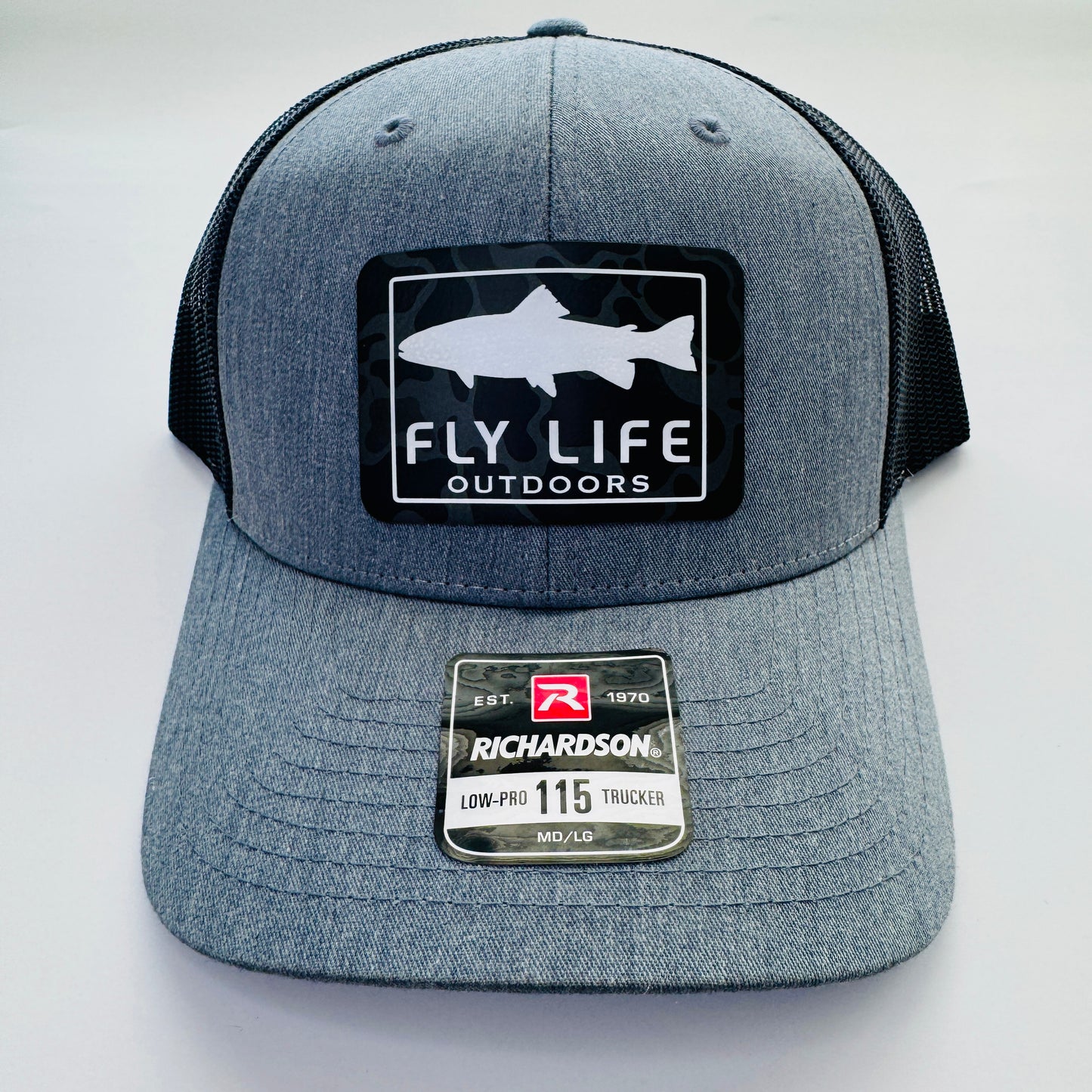 Front view of The FLO 115 Trucker in Heather Grey with White Trout/Black Skies Camo patch | Heather Grey/Black