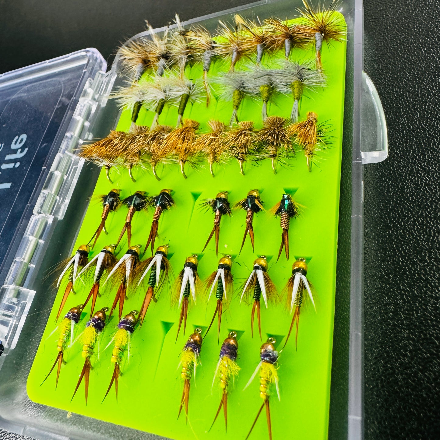 An angler's pocket-sized fly box, fully loaded with 42 proven trout patterns from Fly Life Outdoors.