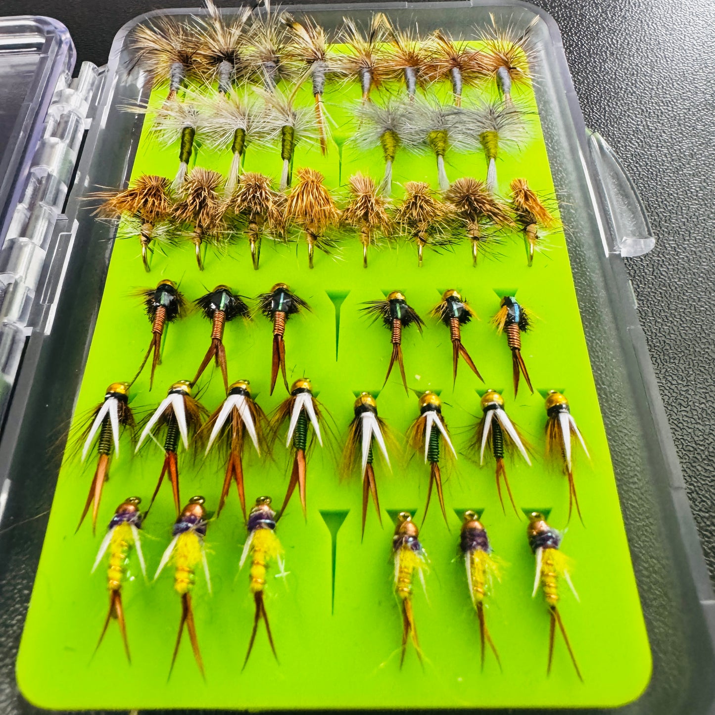 A compact, grab-and-go fly box loaded with a curated assortment of essential nymphs and dry flies.