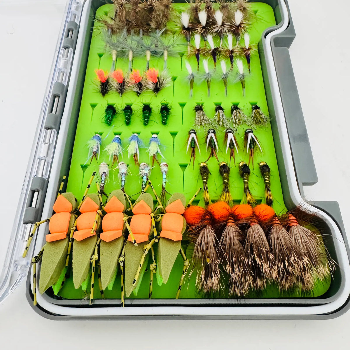 Angled close-up of All-Water Arsenal nymphs, green Morrish Hoppers with orange sight markers, Glo Bug Eggs, and Stimulators.