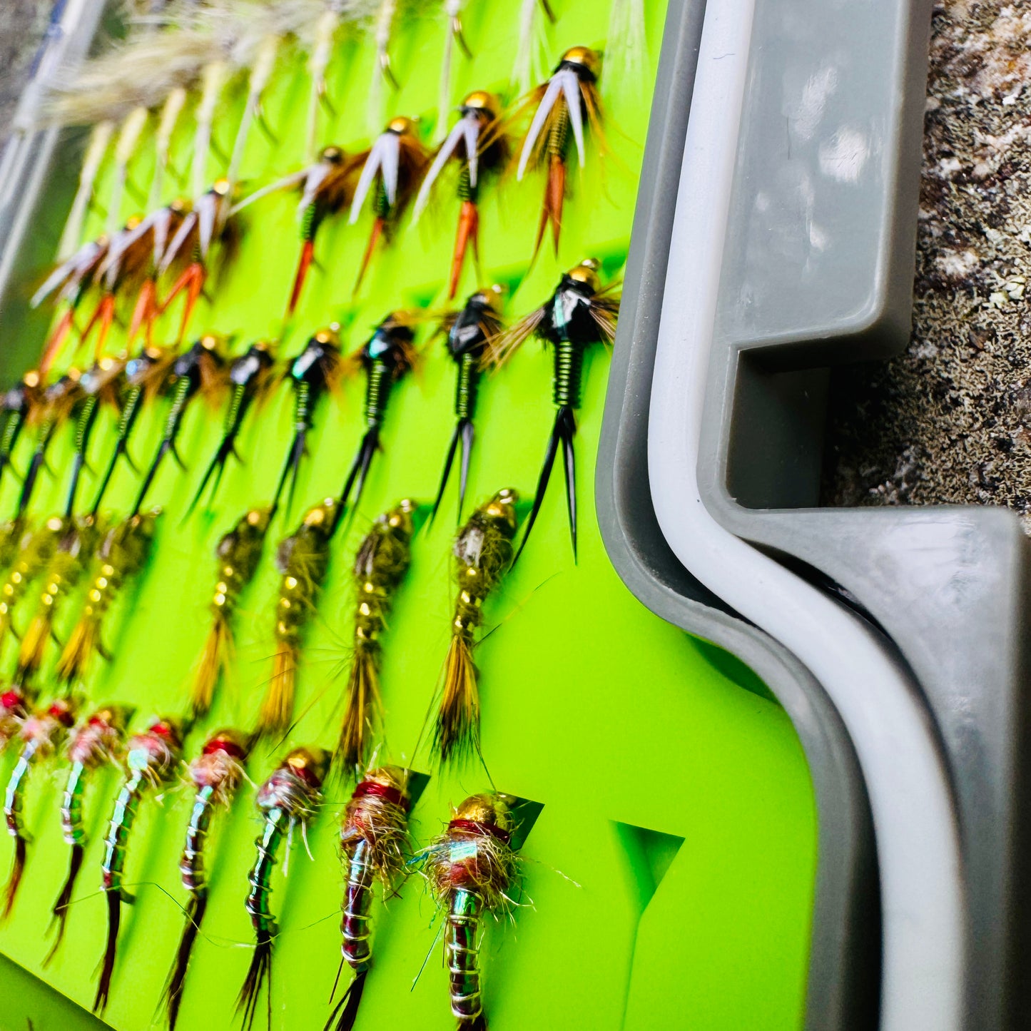 A detailed close-up of the dry fly selection in The Essentials Fly Box, including Prince Nymphs and Rainbow Warriors.