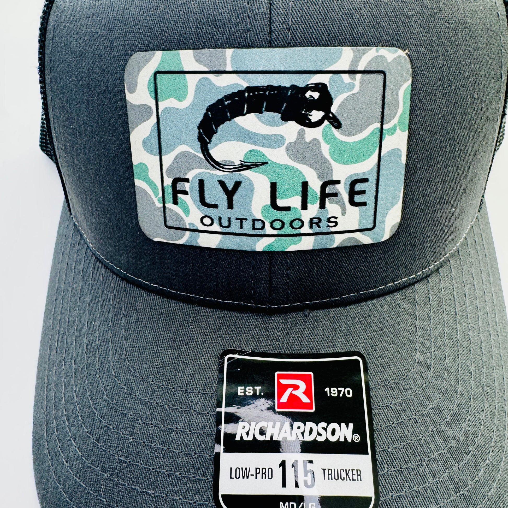 Close up patch view of The FLO 115 Trucker in Charcoal with Black Midge/Low Tide Camo patch | Charcoal/Black