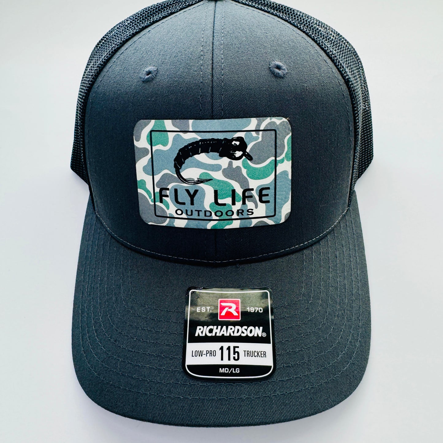 Front view with patch of The FLO 115 Trucker in Charcoal with Black Midge/Low Tide Camo patch | Charcoal/Black