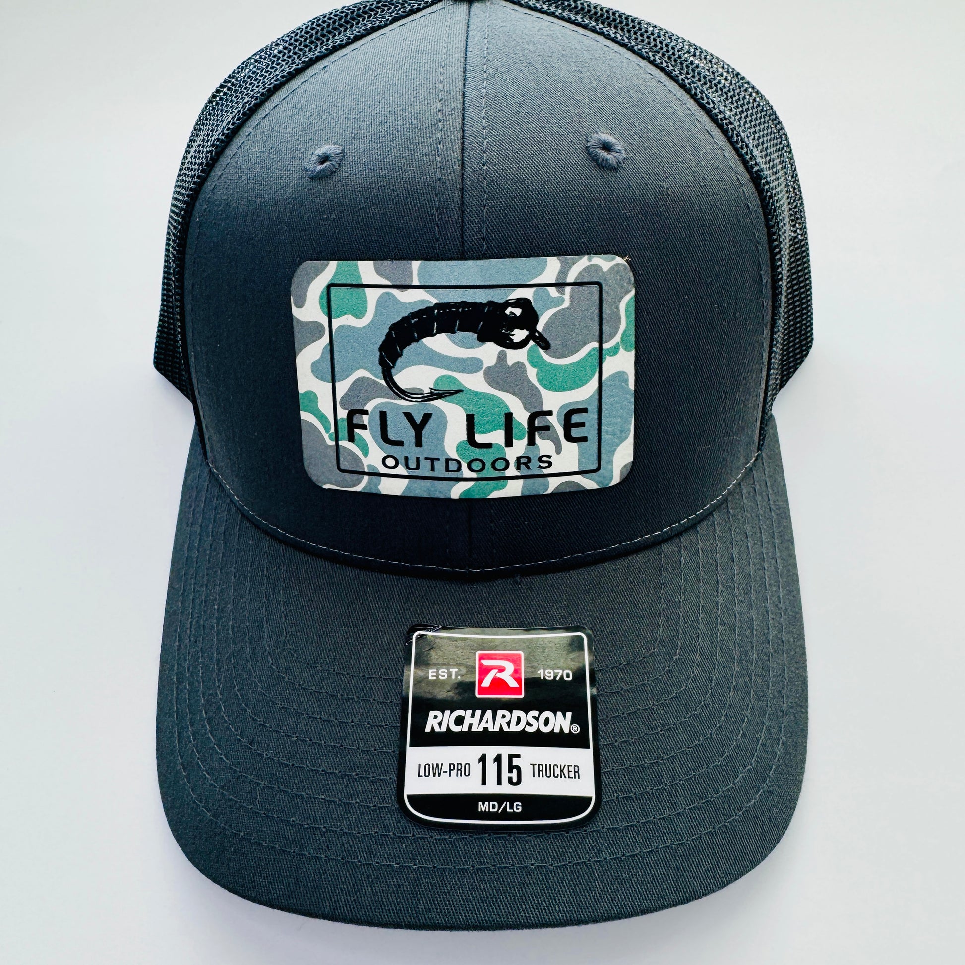 Front view with patch of The FLO 115 Trucker in Charcoal with Black Midge/Low Tide Camo patch | Charcoal/Black