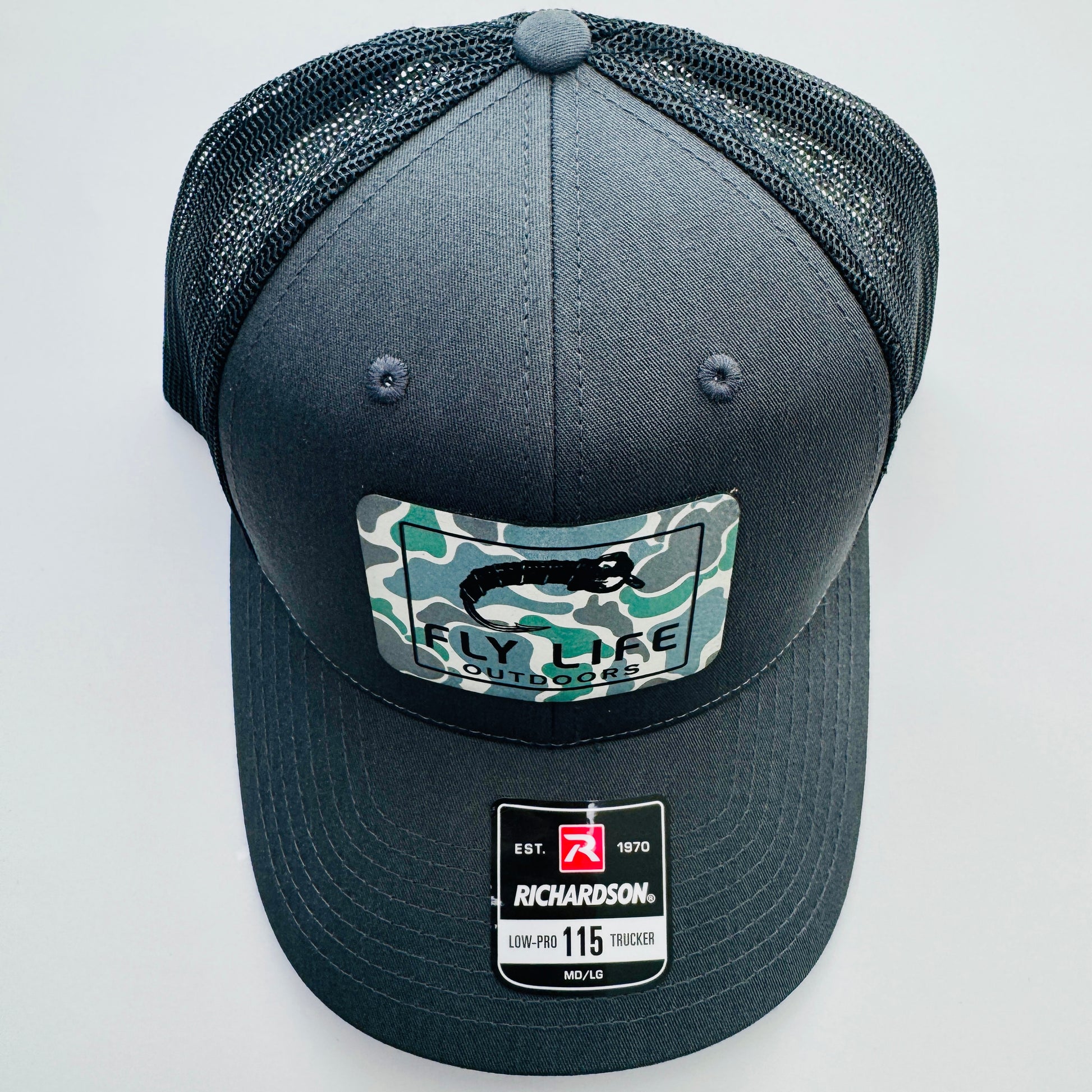 Top view of The FLO 115 Trucker in Charcoal with Black Midge/Low Tide Camo patch | Charcoal/Black