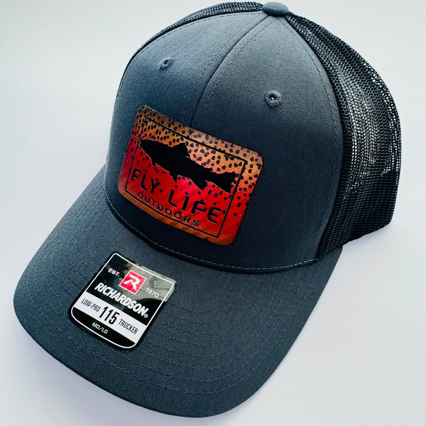 Right angle view of The FLO 115 Trucker in Charcoal with Black Trout/Cutthroat patch | Charcoal/Black