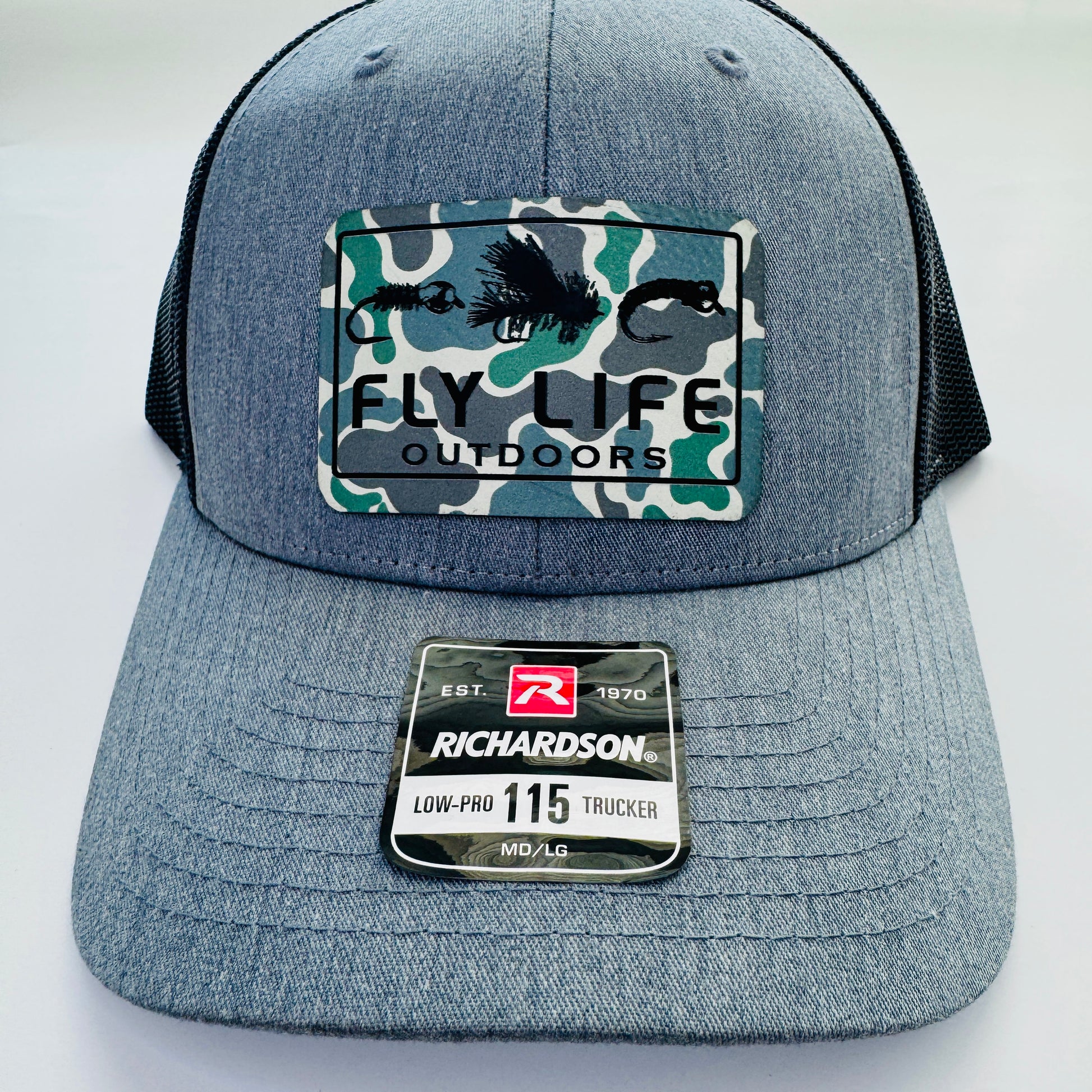 Front view of The FLO 115 Trucker in Heather with Black Tri-Fly/Low Tide Camo patch | Heather Grey/Black