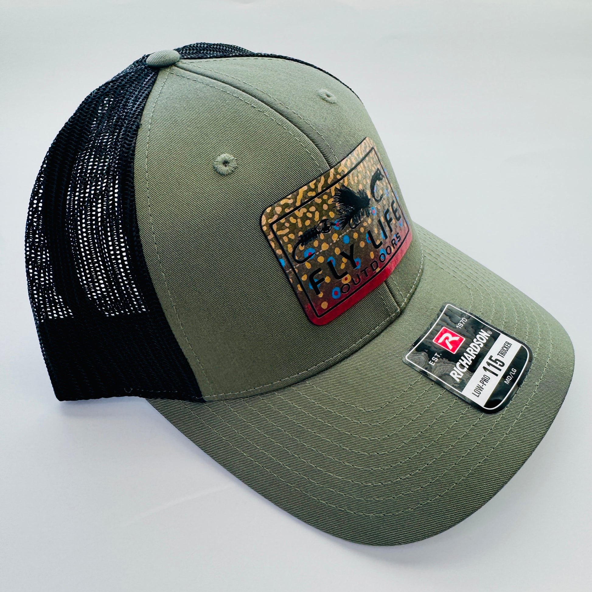 Left angle view of The FLO 115 Trucker in Olive with Black Tri-Fly/Brook Trout patch | Olive/Black