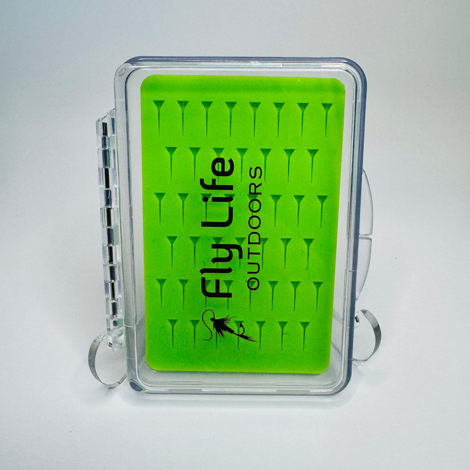 Close-up of the bright green silicone insert in The Outpost Slim Fly Box, designed to grip small nymphs and dry flies securely.